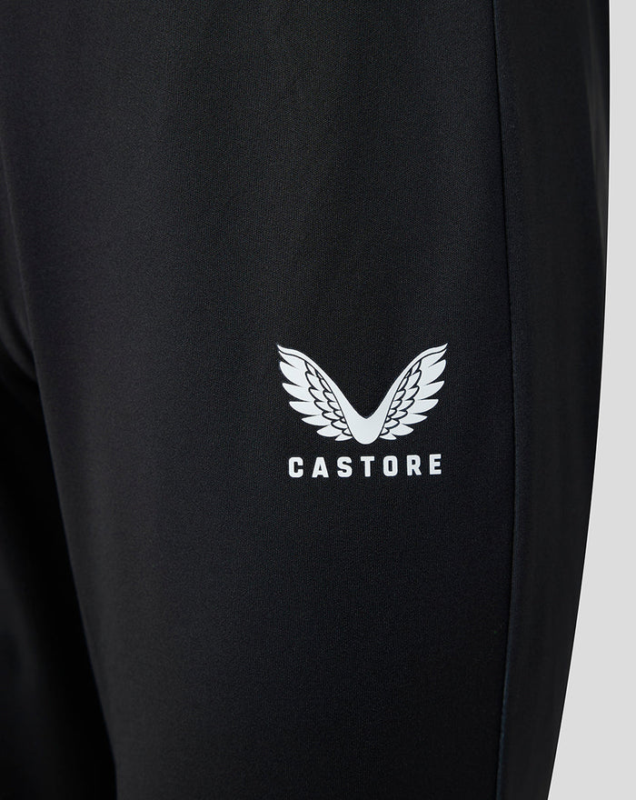 Close-up of white wing logo with Castore text on black pants