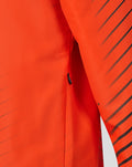 Detail of side zip pocket on bright orange jacket with diagonal stripes.