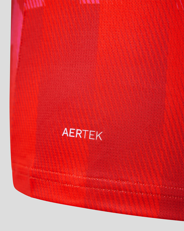 Shoulder and chest area of red Welsh Fire jersey showing AERTEK fabric and pink geometric print