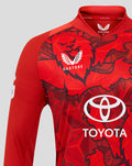 Front close up of red T20 Pro shirt showing bold graphic print and Castore collar detail