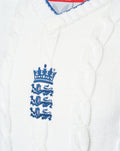 White knitted England cricket test sweater with a blue embroidered three lions crest on the chest.