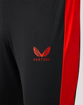 Close up of black Welsh Fire sub slim fit pant with red side panel and Castore logo