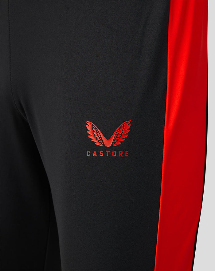 Close up of black Welsh Fire sub slim fit pant with red side panel and Castore logo