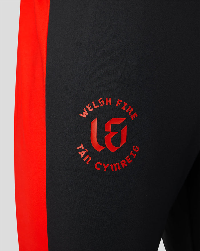Close up of black pant with red side panel and Welsh Fire crest on thigh
