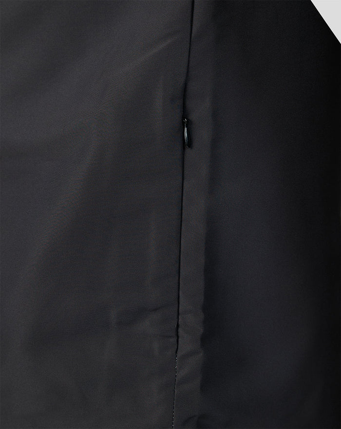 Close up of the zip and seam on a dark Welsh Fire woven pre match jacket