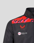 Shoulder detail of a black Castore jacket with red pink pattern crest and Vitality sponsor logo