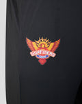 Close up of the Sunrisers Leeds crest embroidered on the left leg of black fabric.