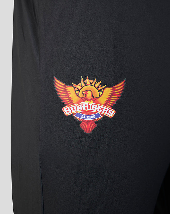 Close up of the Sunrisers Leeds crest embroidered on the left leg of black fabric.