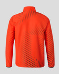 Back view of bright orange red woven pre match jacket with black diagonal stripe pattern across back and shoulders