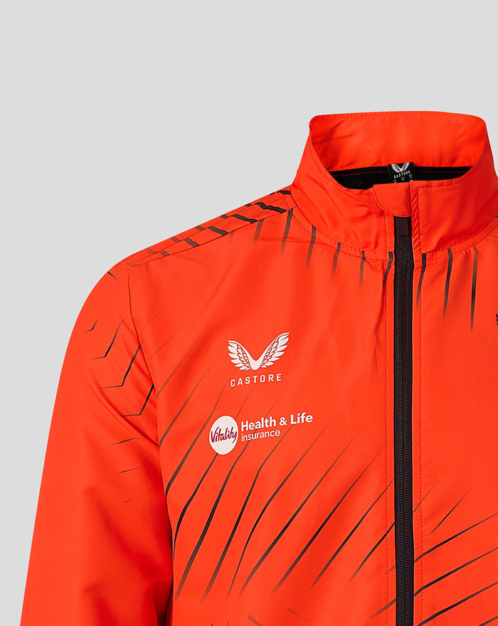 Chest area of bright orange jacket showing Castore logo and Vitality sponsor with diagonal line print