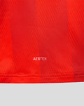Close-up of red jersey fabric with AERTEK branding near the hem.