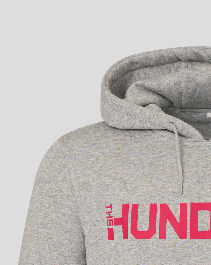 Grey hooded sweatshirt close up showing a pink The Hundred logo across the chest