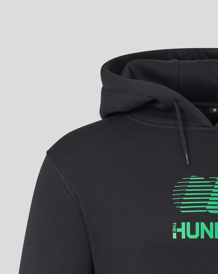 Close up of black hoodie hood and shoulder with partial neon green graphic visible