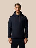 Front view of a model wearing the navy Ashes Travel hoodie with red drawcords and shoulder stripe detail